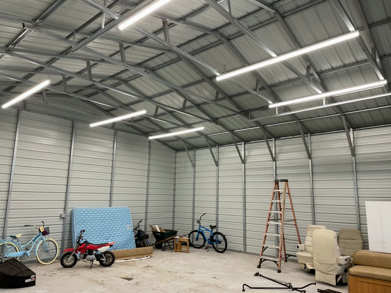 Rows of new LED strip lights across the ceiling of a steel building, installed by Stagg Electric