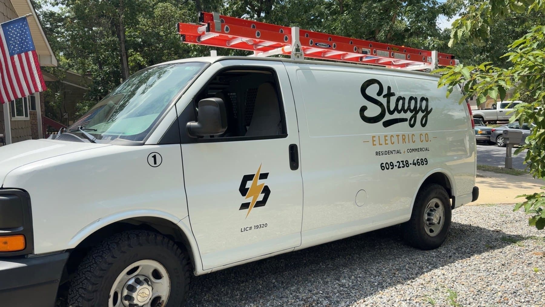 The Stagg Electric Company work truck, lettered with the license number and phone, parked at a job